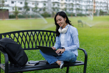 Asian female college student thinking outside with bag and book in a park, Education studying...