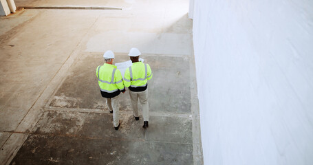 Construction, walking and above of men with blueprint for collaboration, building ideas or...
