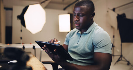 Black man, photographer and browse on tablet in studio for production, editing image and retouch. Person, digital and review catalog for picture, website update and backstage with photoshoot results