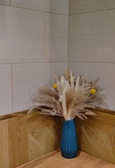vibrant dried flower arrangement featuring pampas grass and decorative elements sits prominently in...