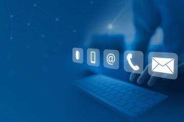 A person uses a laptop, with glowing contact icons appearing above the keyboard, representing customer support options