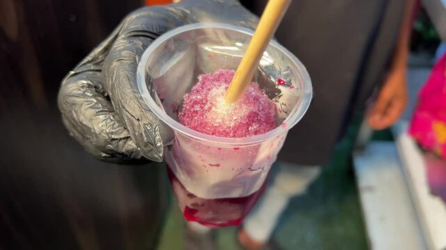 Kala khata ice gola prepared in a street shop in Kolkata, India 