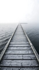 Fototapeta premium Wooden pier stretching into a dense white fog over calm water creating a mysterious and serene atmosphere
