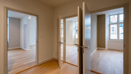 Bright Empty Apartment with Open Wooden Doors and Natural Light on Hardwood Floors