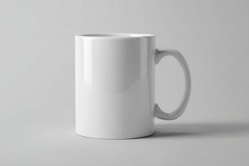 Fototapeta premium Simple white ceramic mug on a neutral gray background. Ideal for branding, coffee shop promotions, and product display mockups. High quality