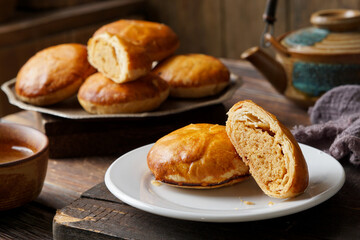 Close Up of Traditional Tau Sar Piah Chinese Pastry with Mung Bean Filling on Rustic Surface