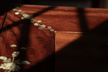A close-up of intricate mother-of-pearl inlay on a traditional piece of Vietnamese wooden...