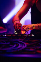 close-up on the hands and equipment of a DJ