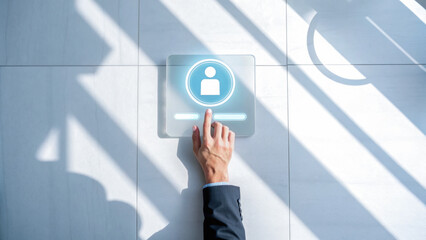 Hand pressing a digital button on a modern wall panel.