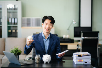 Smiling businessman saves money with piggy bank and coins; ideal for themes of finance, savings,...