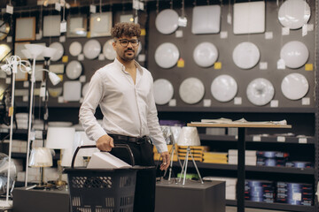 Man Exploring Home Lighting Options in a Modern Store with Samples Displayed