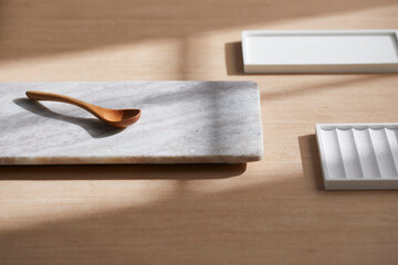 Light and Shadow on Wooden Texture with Modern Objects. Minimal Home Decor Scene with Ceramic Trays.