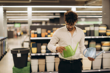 Man Selecting Watering Cans in a Gardening Supplies Store