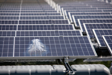 Selective focus to damaged solar panels. Solar photovoltaic power station on water. Solar panels or...