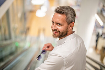 Elegant man in business center. Man shopping mall, banner. Airport and business travel....