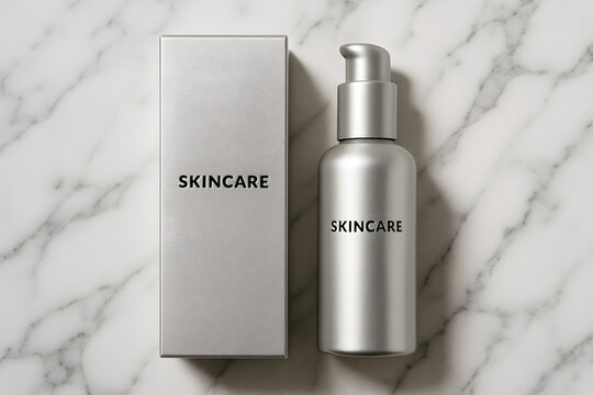 Fototapeta Skincare Essentials: A minimalist still-life photograph of a sleek skincare product, a silver pump bottle and its matching box, on a sophisticated marbled surface.