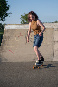 Young girl riding on her skateboard, outdoor kids activities