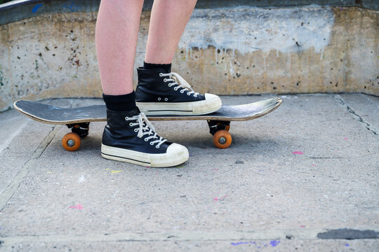 Young girl riding on her skateboard, outdoor kids activities