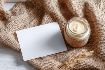 Natural cream jar on burlap with blank card flatlay
