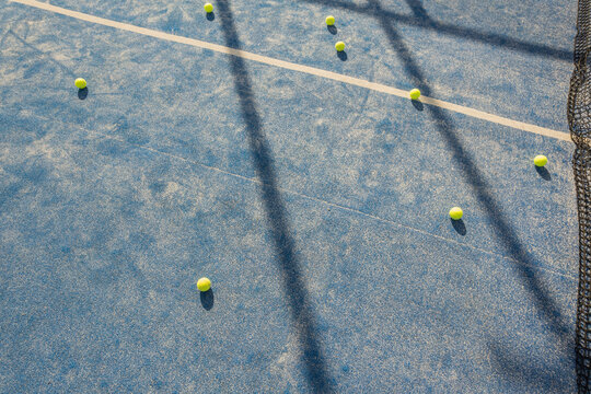balls in a padel tennis court at sunset