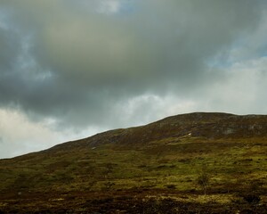 Alpine mountain slope with storm clouds