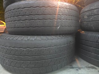 Macro shot of worn-out rubber car tires showing aged surfaces and detailed tread patterns. Perfect...