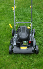 Brand new lawnmower in long grass, ready for work