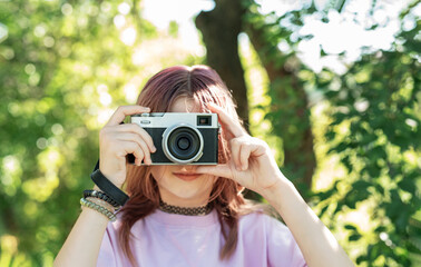 Young photographer capturing nature with vintage camera