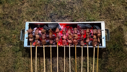 Traditional Indonesian Satay Grilling on Charcoal BBQ at Night