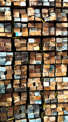 Stack of Square Wooden Beams with Natural Texture for Construction Material Background