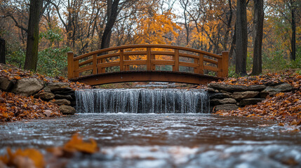 hidden waterfall flowing through autumn woodland with rustic wooden bridge and vivid fall foliage