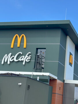 Parndorf, Austria - 25 May 2025: mccafe and mcdonalds logos on a modern restaurant building, concept of fast food, coffee shop, dining