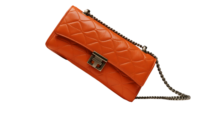 Bright orange quilted leather clutch with silver chain and clasp isolated on a transparent background