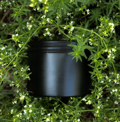 Cream mockup - black jar with space for label in grass