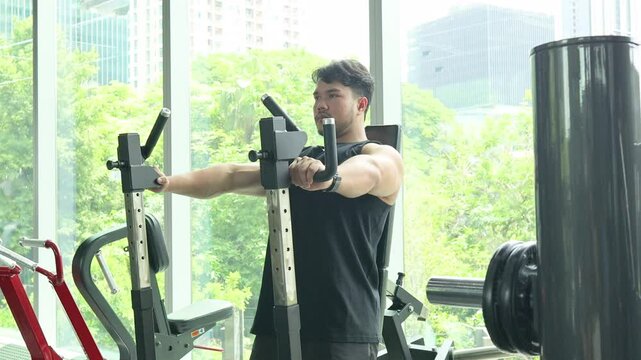 Man Exercising on Chest Press Machine in Gym