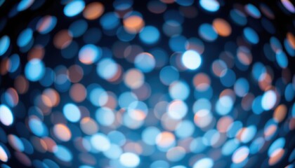 Abstract colorful bokeh background with blurred circles of light in blue, orange, and white hues creating a dreamy and festive atmosphere for visuals