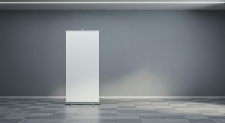 Minimalist indoor space with a white banner stand against a gray wall. Soft, focused lighting enhances simplicity and readiness for presentations.