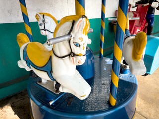 A view of a coin operated carousel child ride.