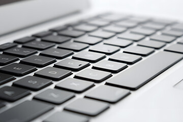 A detailed side-angle view of a laptop keyboard showcases modern, slim keys and metallic edges. The clean design and sharp focus evoke technology and minimal productivity. Suitable for digital tools, 