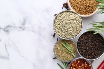 Different aromatic spices on white marble table, flat lay. Space for text