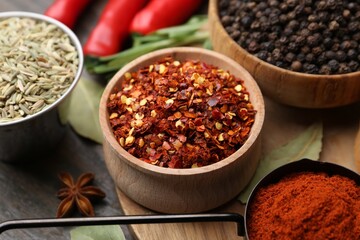 Different aromatic spices on wooden table, closeup