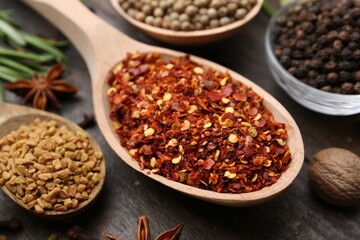 Different aromatic spices on wooden table, closeup