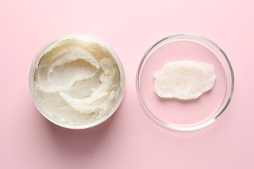 Natural scrub in Petri dish and jar of cosmetic product on pink background, flat lay