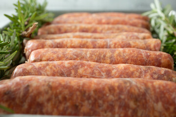 A closeup view of a baking sheet of Italian sausage.
