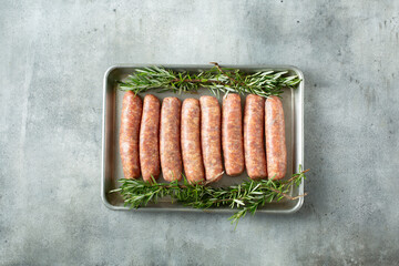 A top down view of a baking sheet of Italian sausage.