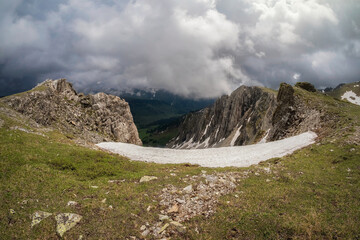 Snow dome and colorful rocky peaked top