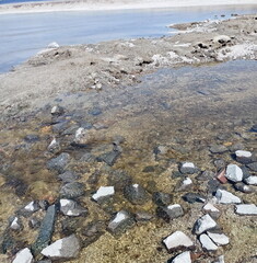 View from above on the Dnieper current rolling through the stones in shining streams under the rays of the sun.