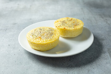 A view of two egg bites, on a plate.