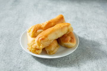A view of a pile of senorita bread, on a plate.