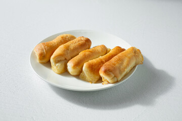 A view of a pile of senorita bread, on a plate.